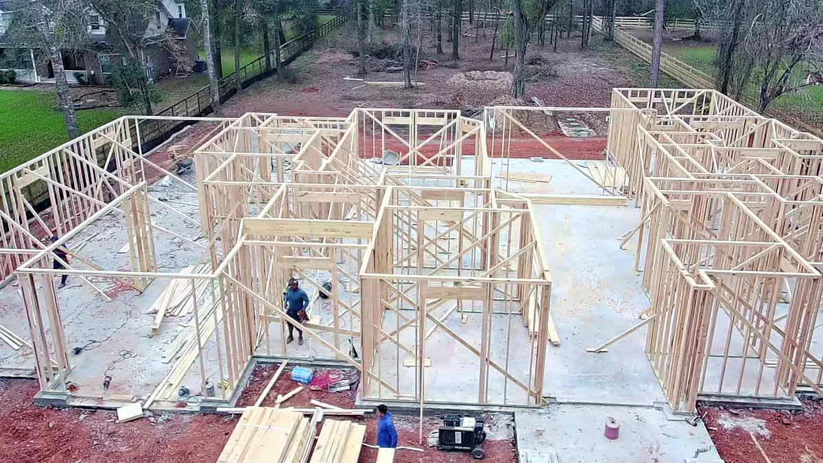 Wall framing going up on a finished concrete slab